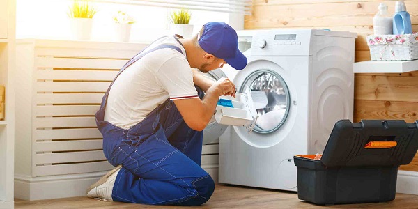 Image of a repair man working on a washer
